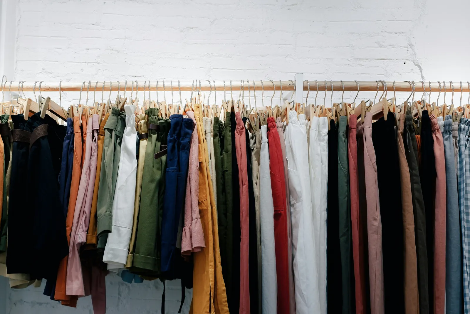 A long rail of colourful second-hand clothing